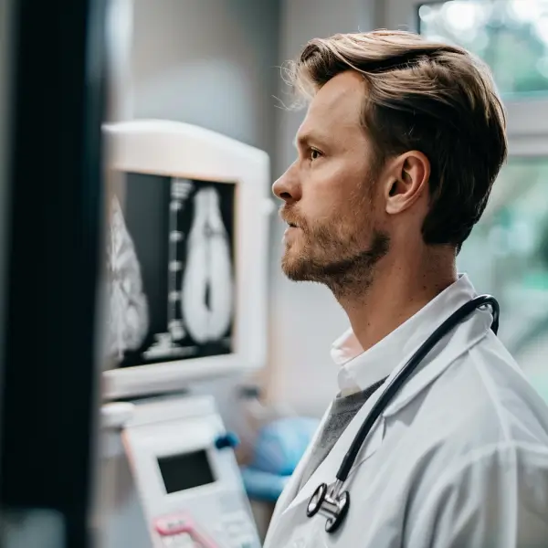 A doctor looking at a Scan machine
